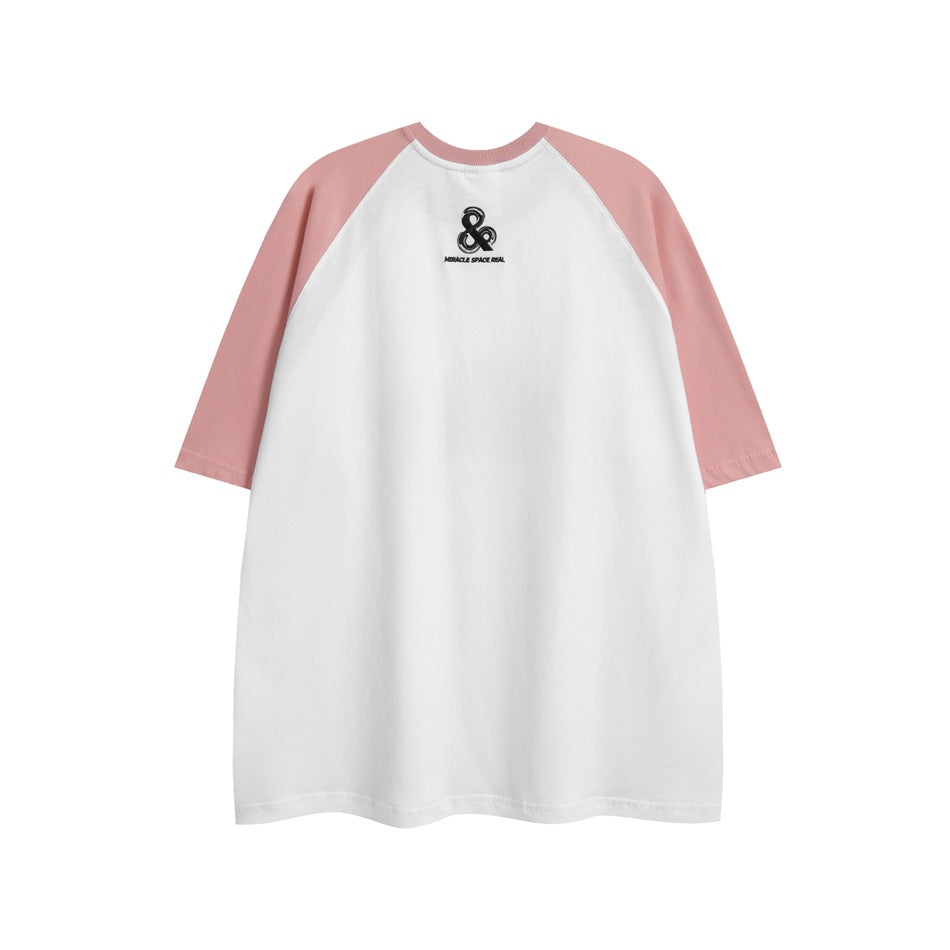 Front view of a white raglan T-shirt with dusty pink sleeves and a small black chest emblem.