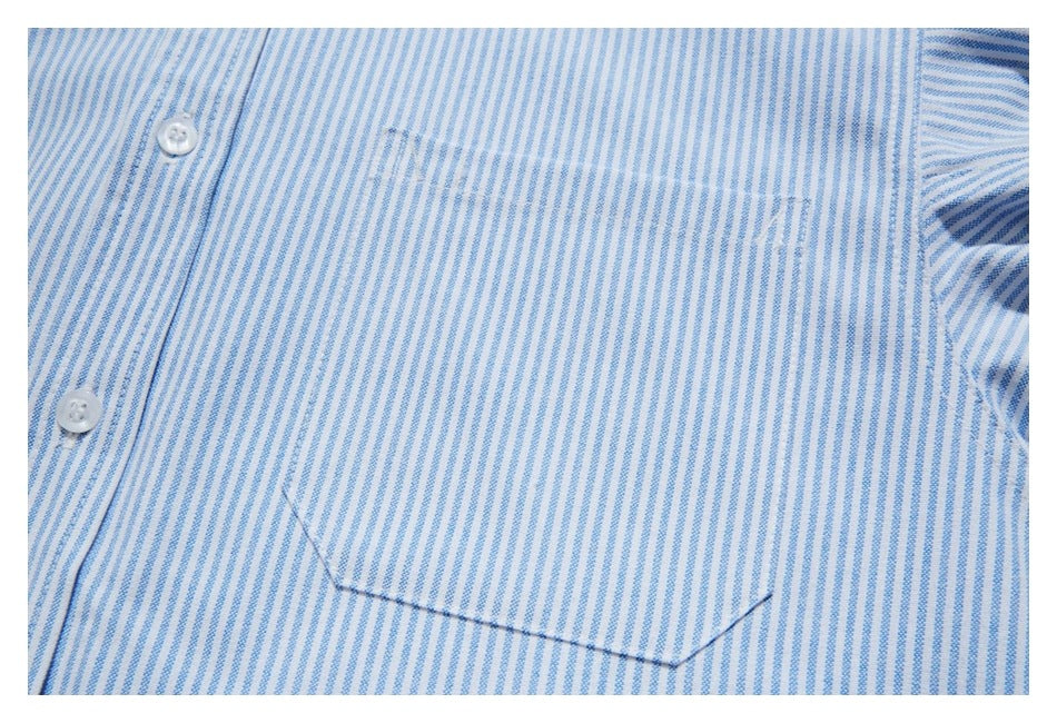 Close-up of a striped shirt chest pocket and white buttons.