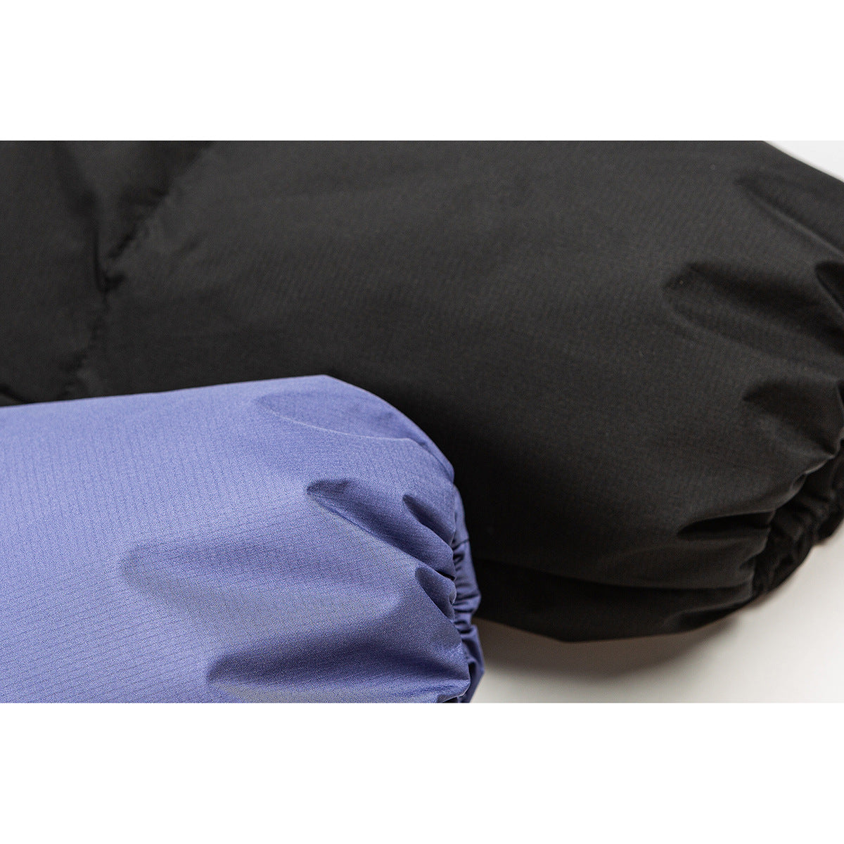 Close-up of blue and black jacket fabric and gathered edges.