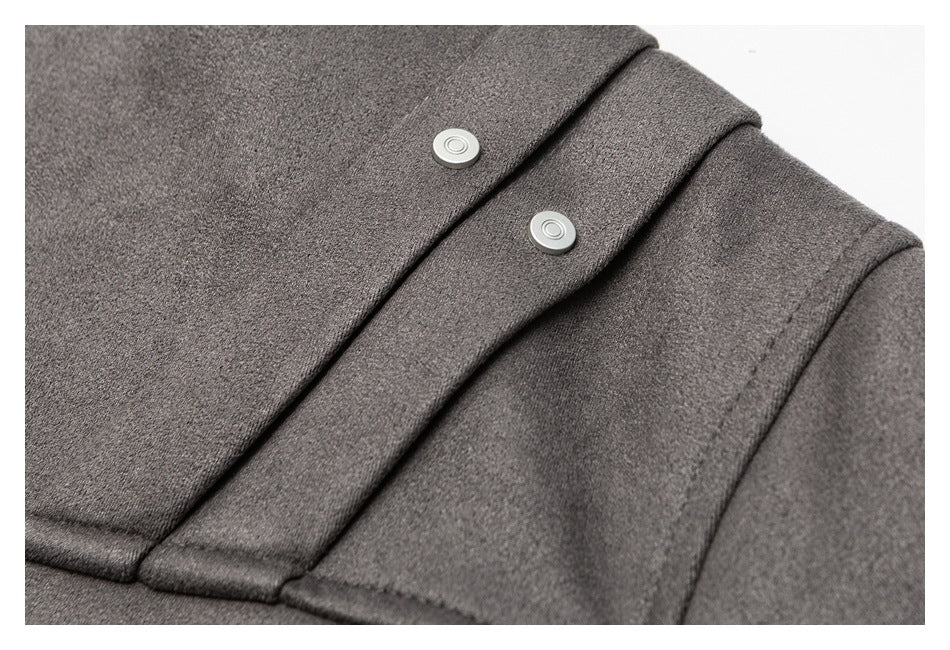 Close-up of two silver snaps on the overlapping front placket of a charcoal gray garment.