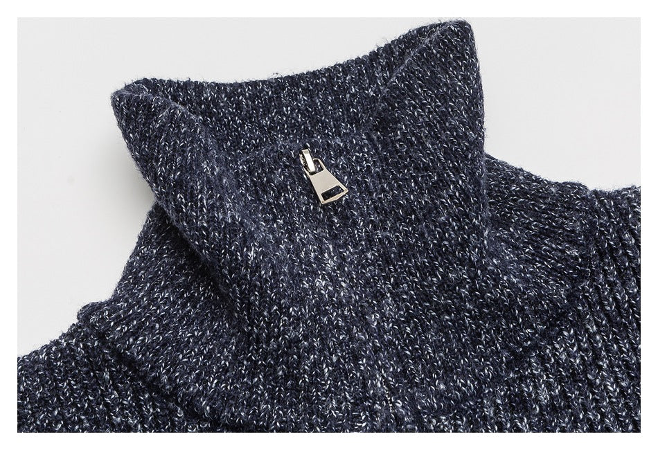 Close-up of the high knit collar and metal zipper pull on a navy marled sweater.