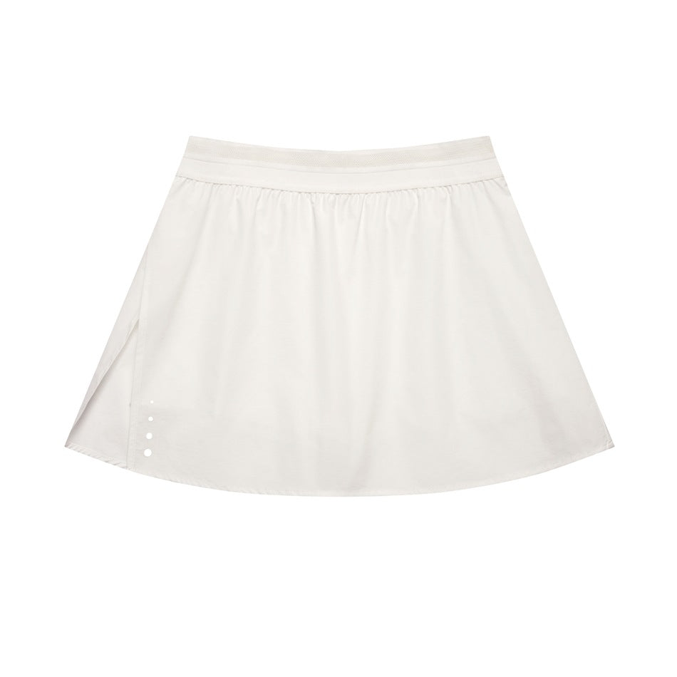 White high-waist A-line mini skirt with elastic waistband, side slit and white dots at the hem, flat lay