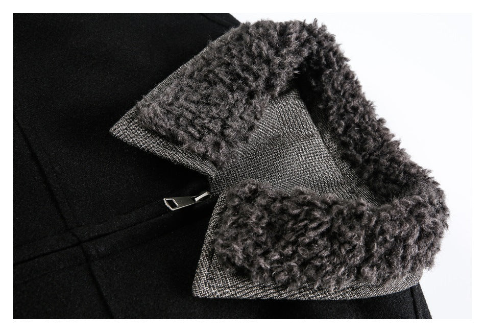 Close-up of a black jacket's dark curly-textured collar, patterned collar underside and metal zipper.