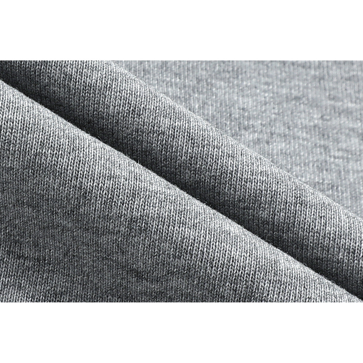 Close-up showing the knit texture of gray T-shirt fabric folded into soft ridges.