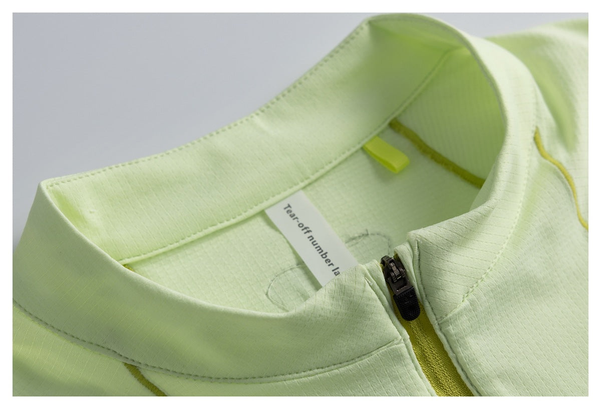 Close-up of a pale lime stand collar and front zipper, with an interior tear-off number label visible.