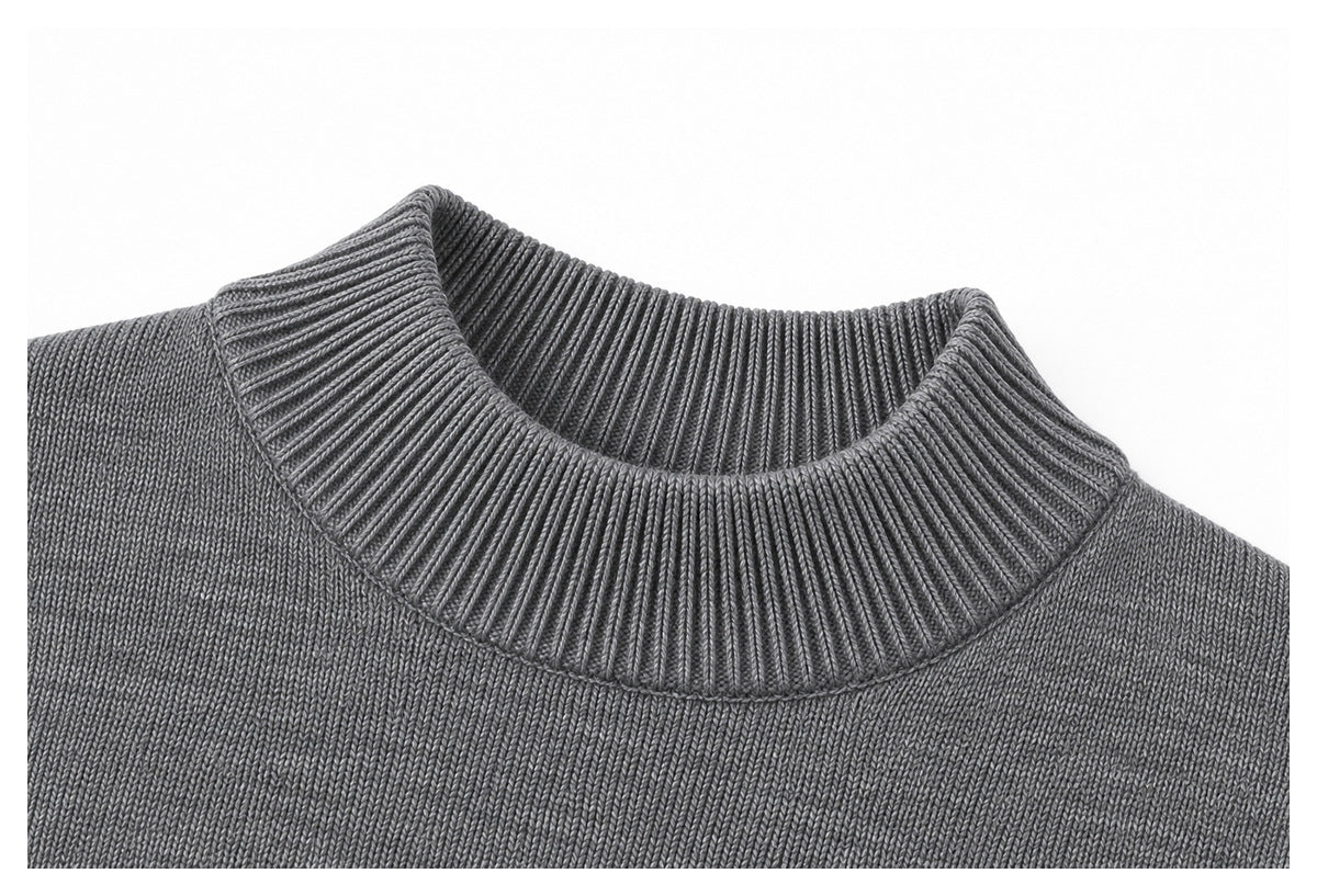 Close-up of the gray sweater's ribbed high collar and textured knit body.