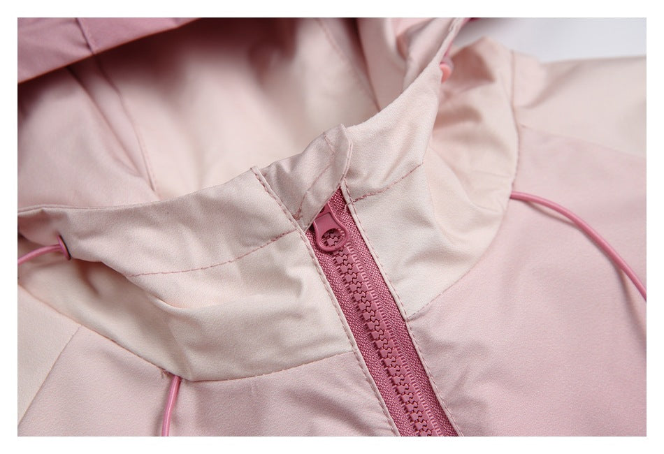 Close-up of a pale pink jacket collar and pink front zipper with the hood lining visible.