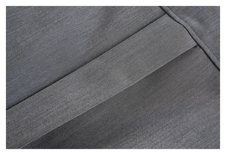 Close-up of charcoal fabric showing a wide stitched seam or folded edge.