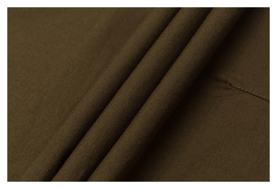 Close-up of folded dark olive-brown garment fabric with a stitched seam.