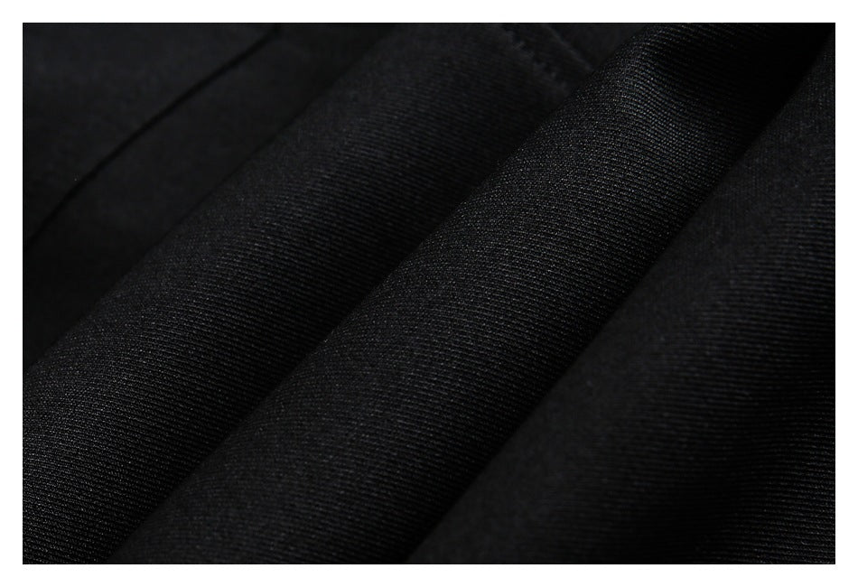 Close-up of folded black fabric showing its subtle woven texture.