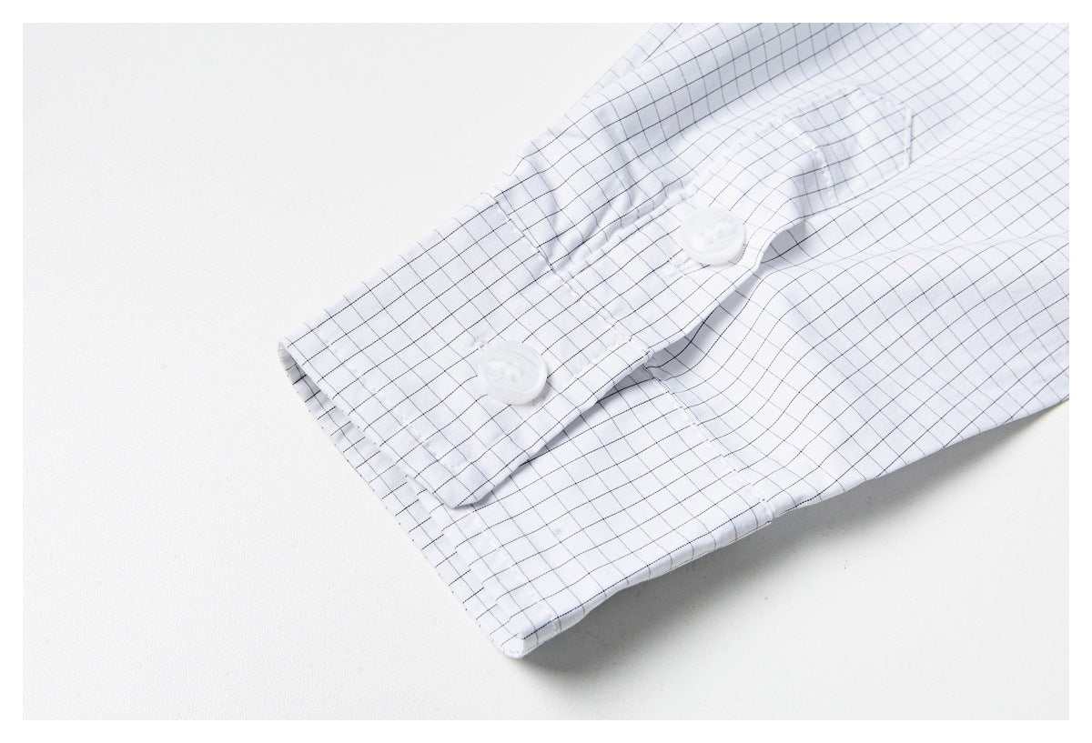 Close-up of a white shirt cuff with a fine black grid pattern and white buttons.