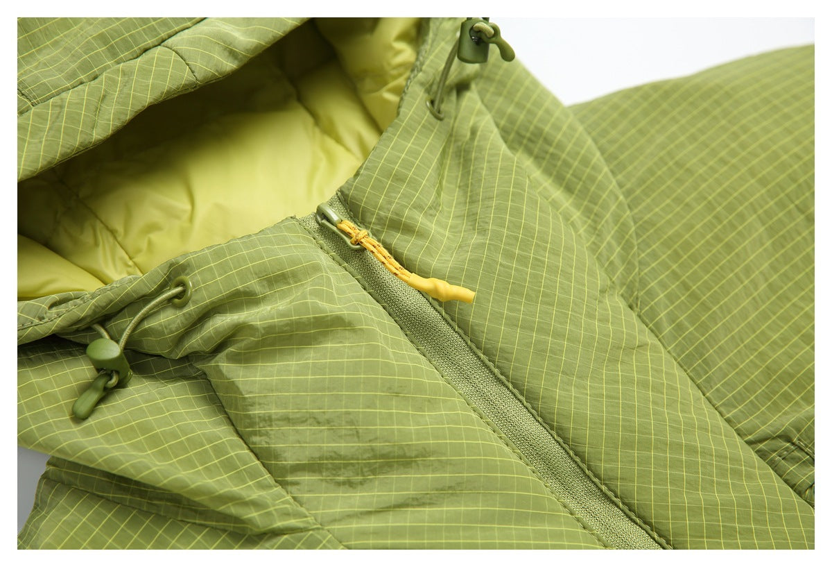 Close-up of the jacket's green grid-pattern fabric, hood drawcord, and zipper with a yellow pull.
