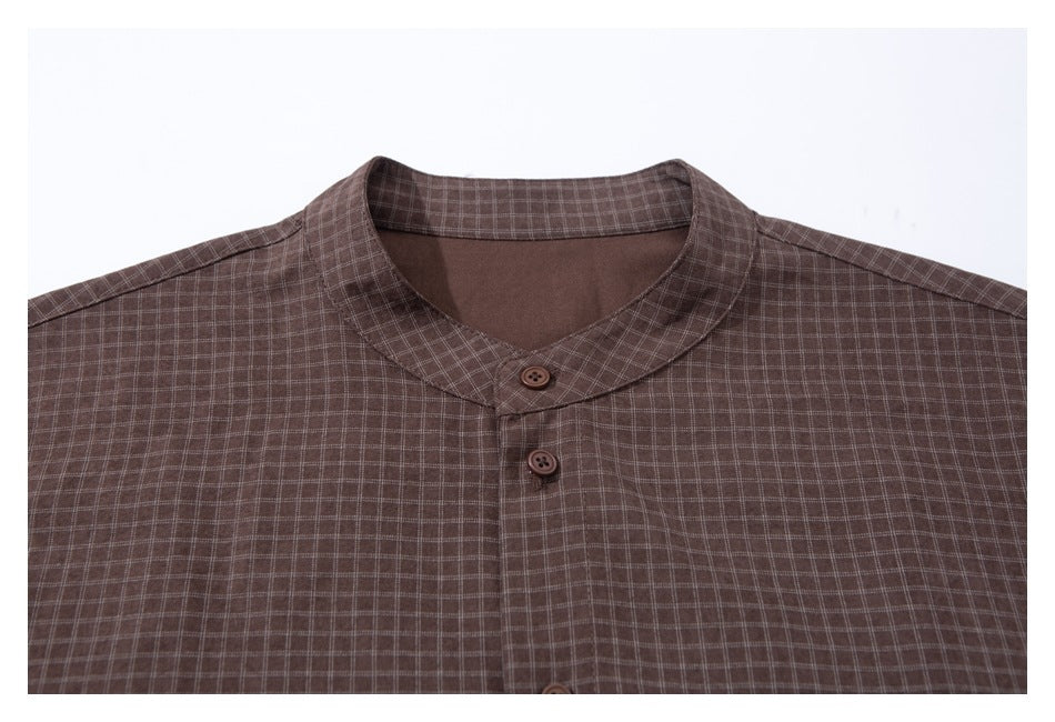 Close-up of a dark brown checked shirt showing its stand collar and front buttons.