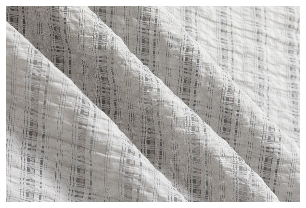 Close-up showing the woven gray-and-white checked pattern and texture of the garment.
