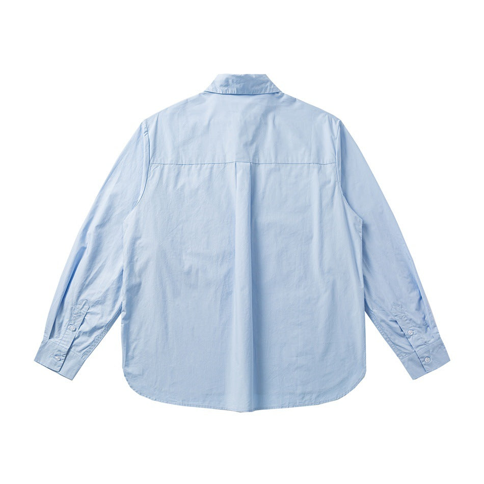 Light blue long-sleeve shirt back view with back yoke, center pleat and buttoned cuffs, flat lay