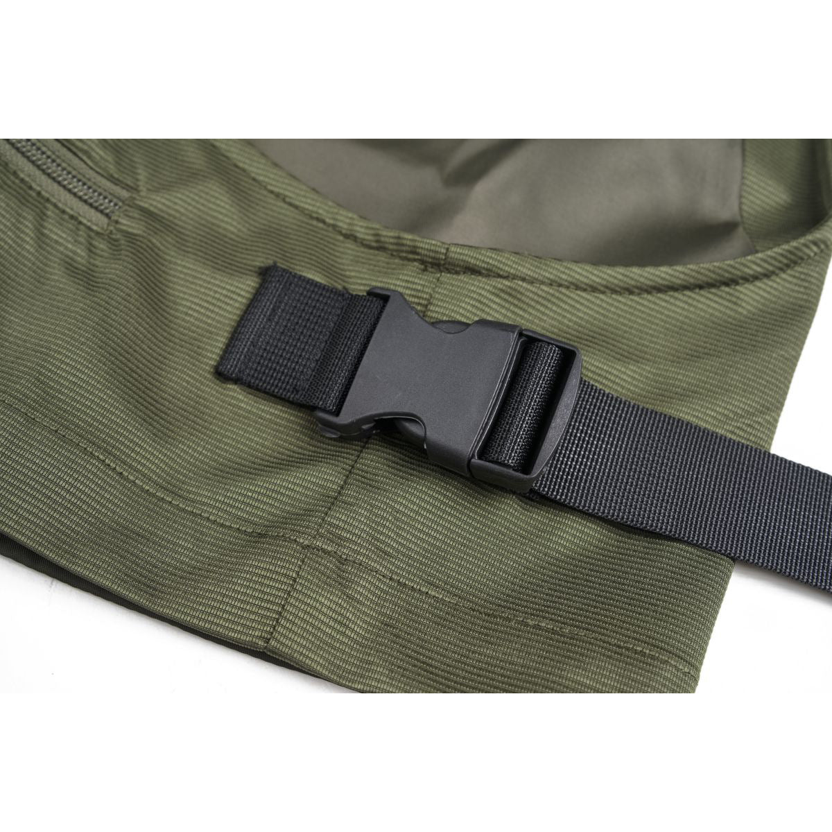 Close-up of an olive-green vest's side adjustment strap and black plastic buckle.