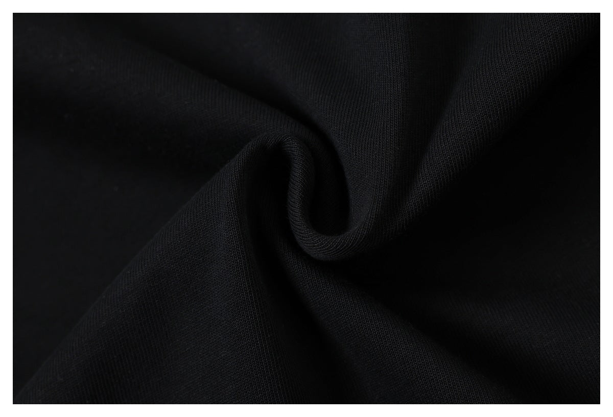 Close-up of black knit fabric gathered into a small fold.