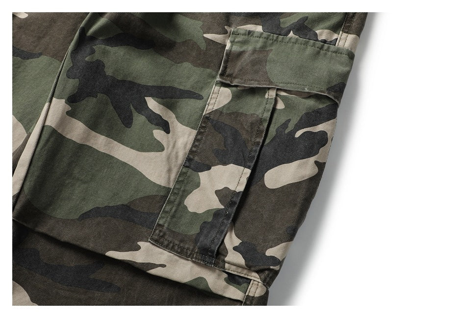 Close-up of a flap cargo pocket on the olive, brown and black camouflage pants.