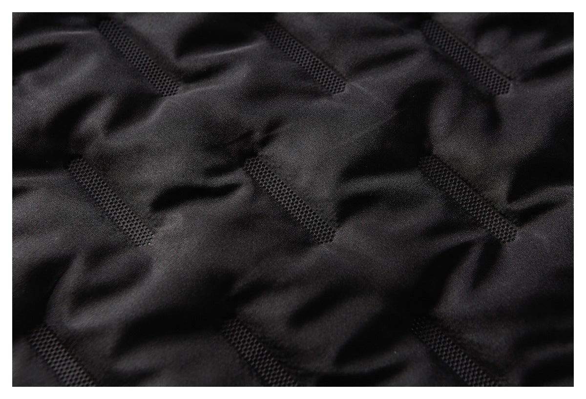 Close-up of black fabric with repeated narrow perforated strips.