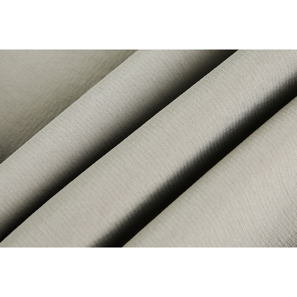 Close-up of beige fabric folded to show its subtle fine grid texture.