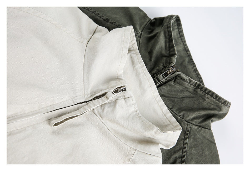 Close-up of cream and charcoal garments showing the waist area, curved bands and short metal zippers.