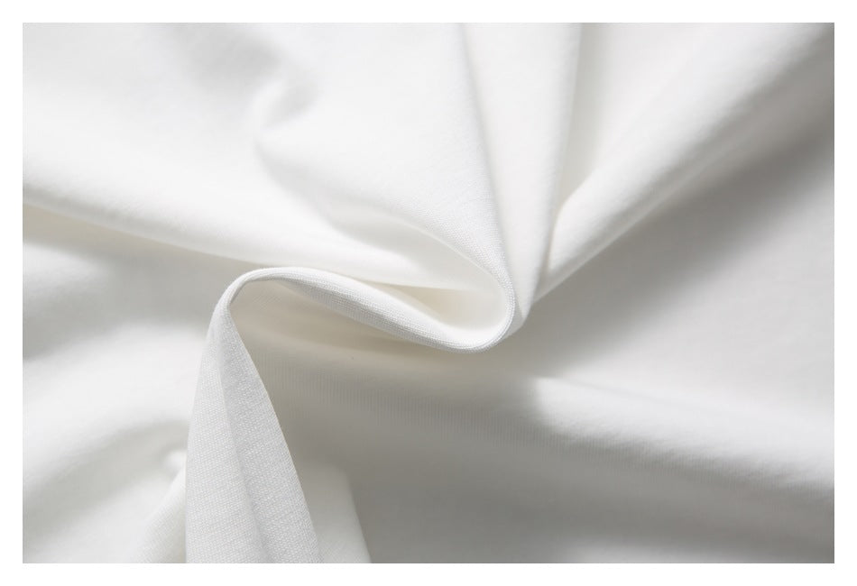 Close-up of white T-shirt fabric draped into soft folds.