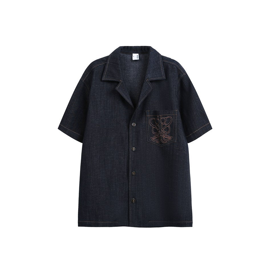 Dark indigo short-sleeve camp collar shirt with button front and embroidered chest pocket, flat front view