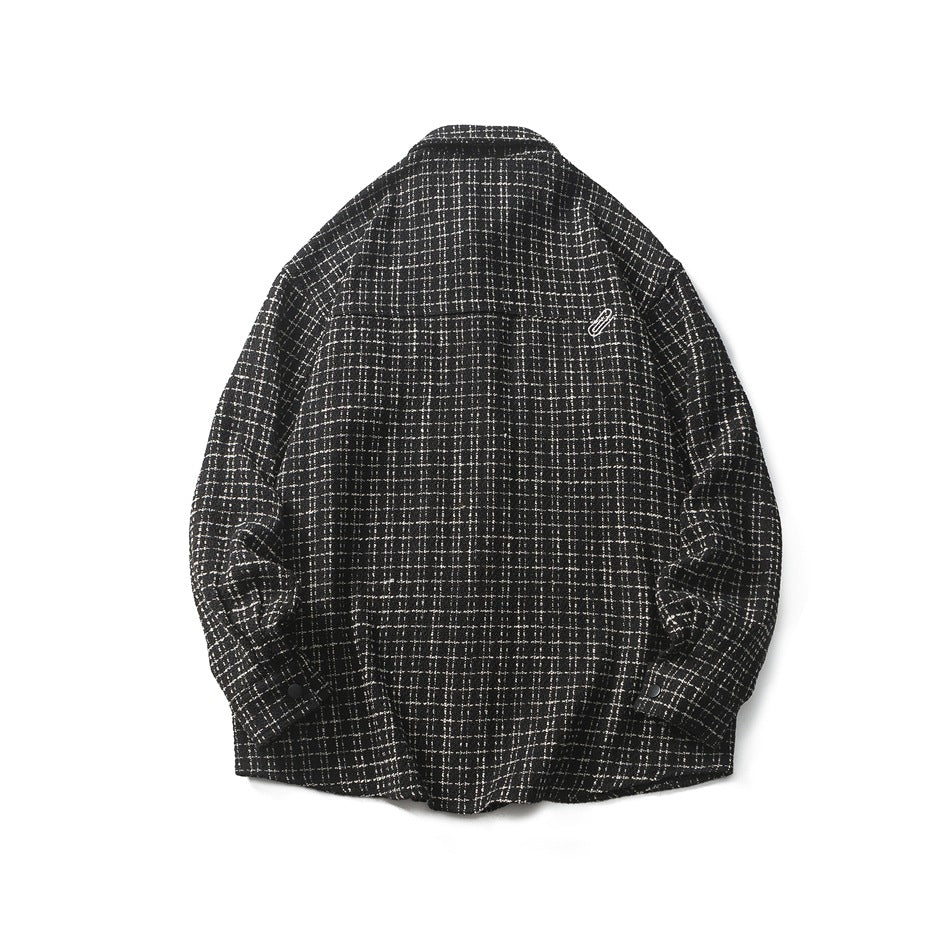 Back view of a black-and-white plaid shirt jacket with long sleeves and a small embroidered emblem, shown against white.
