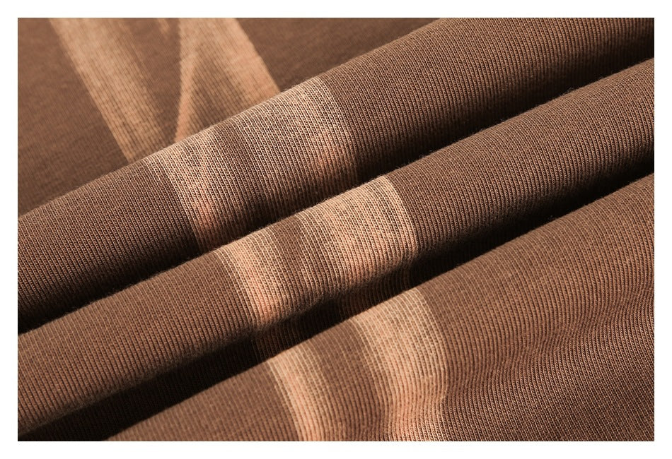 Close-up of brown ribbed knit fabric folded into soft ridges.