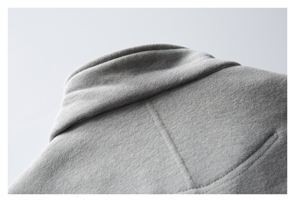Close-up of the light gray sweatshirt hood and stitched seam.