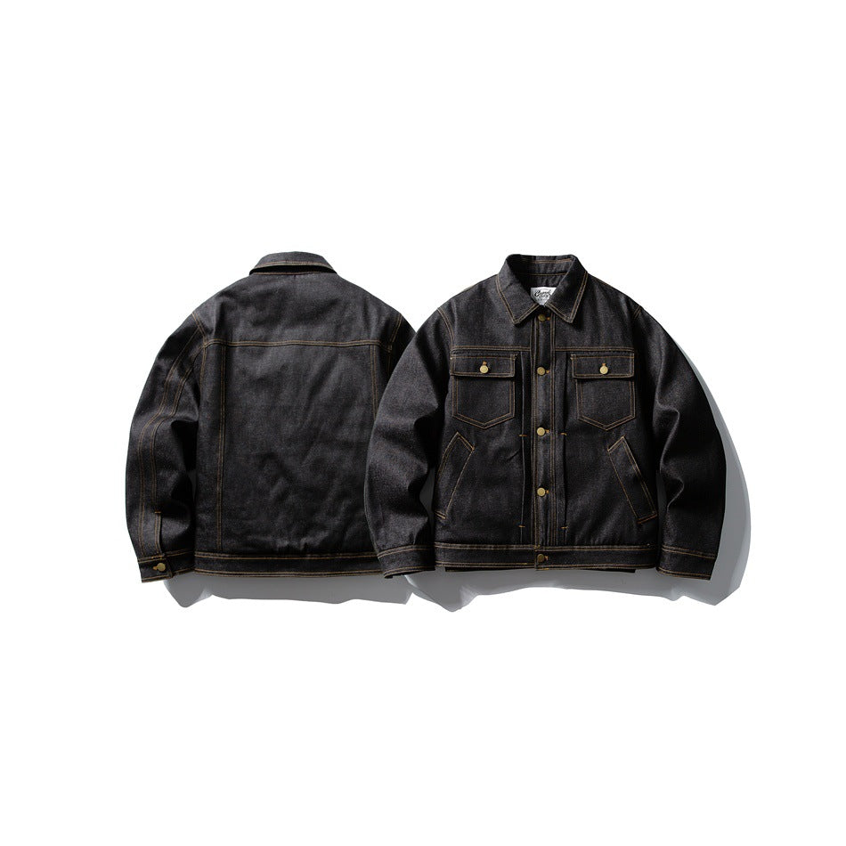 Dark denim jacket shown from the front and back, with golden contrast stitching, flap chest pockets, and brass-tone buttons.