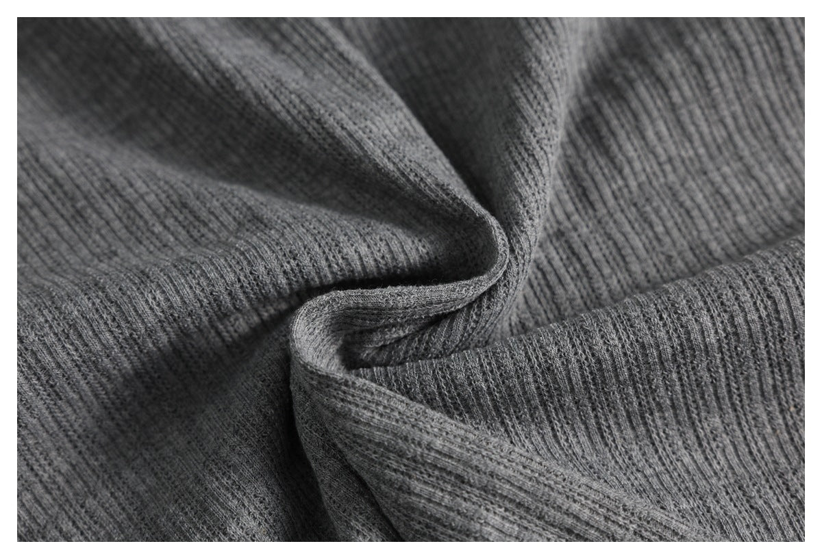 Close-up highlighting the fine vertical ribs and drape of gray knit fabric.