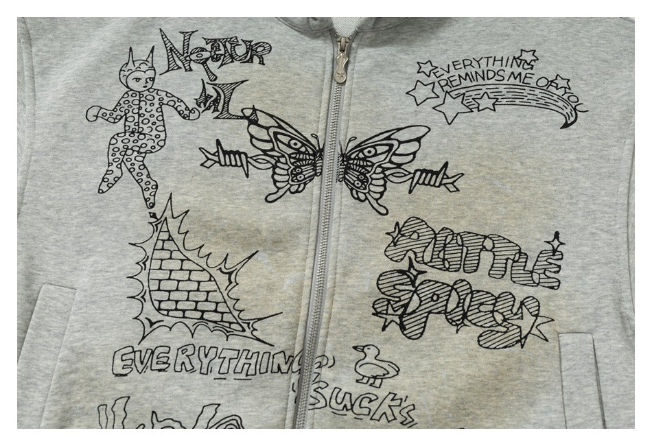 Close-up of a light gray zip hoodie with black doodle-style illustrations and English lettering across the front.