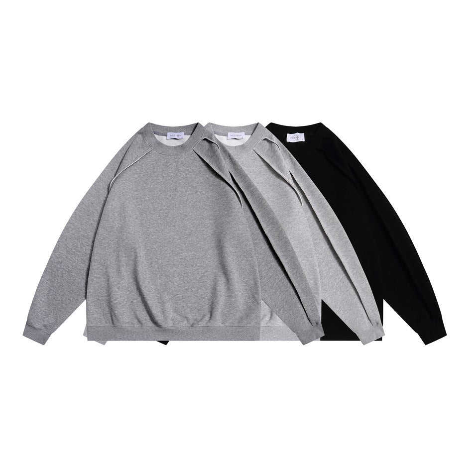 Three raglan crewneck sweatshirts arranged together in gray, light gray, and black.
