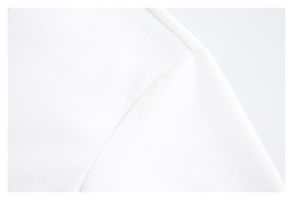 Close-up of white garment fabric with a curved seam.