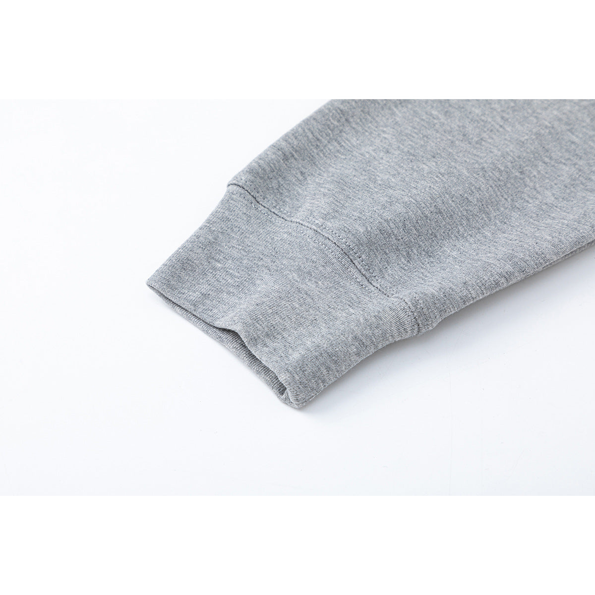 Close-up of a heather gray long sleeve and ribbed cuff.