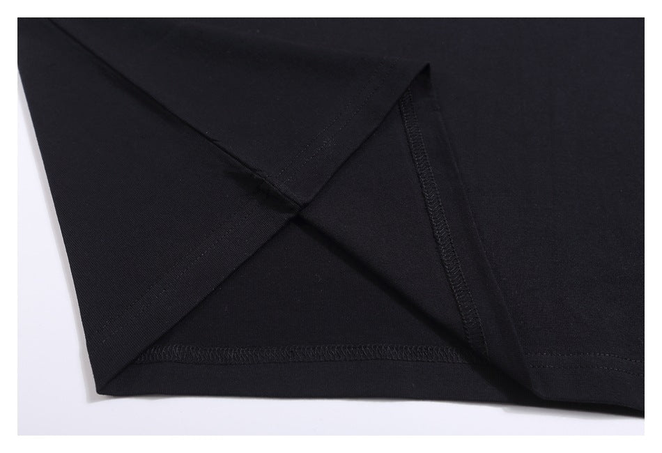 Close-up of the black T-shirt's inside stitching and finished hem.