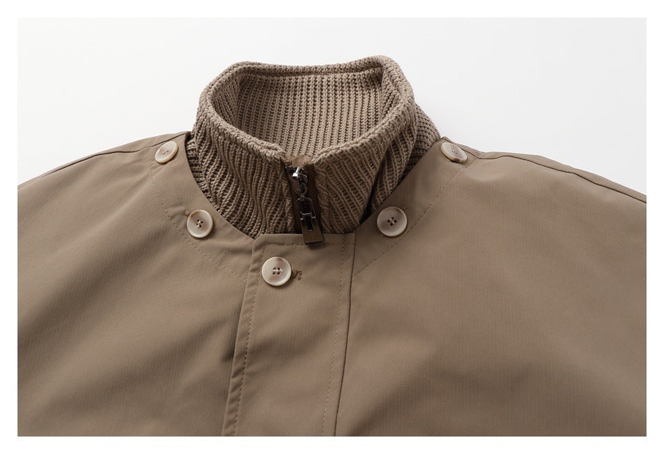 Close-up of a tan coat collar with a rib-knit inner collar, zipper, and buttons.