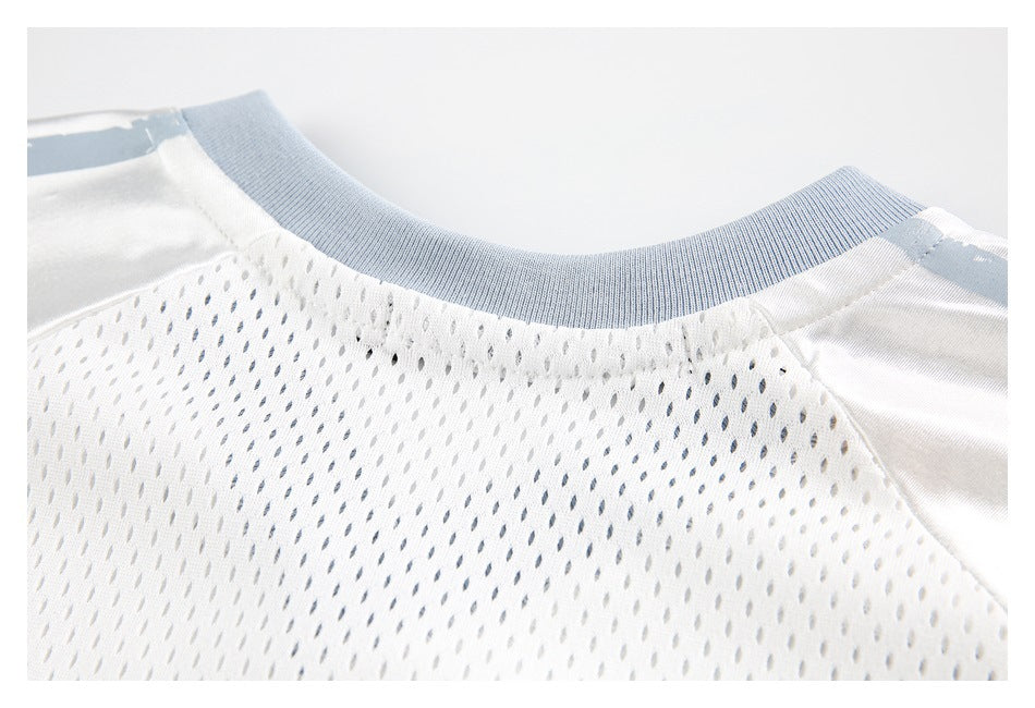 Close-up of a white mesh garment's back neckline with a pale blue ribbed collar.