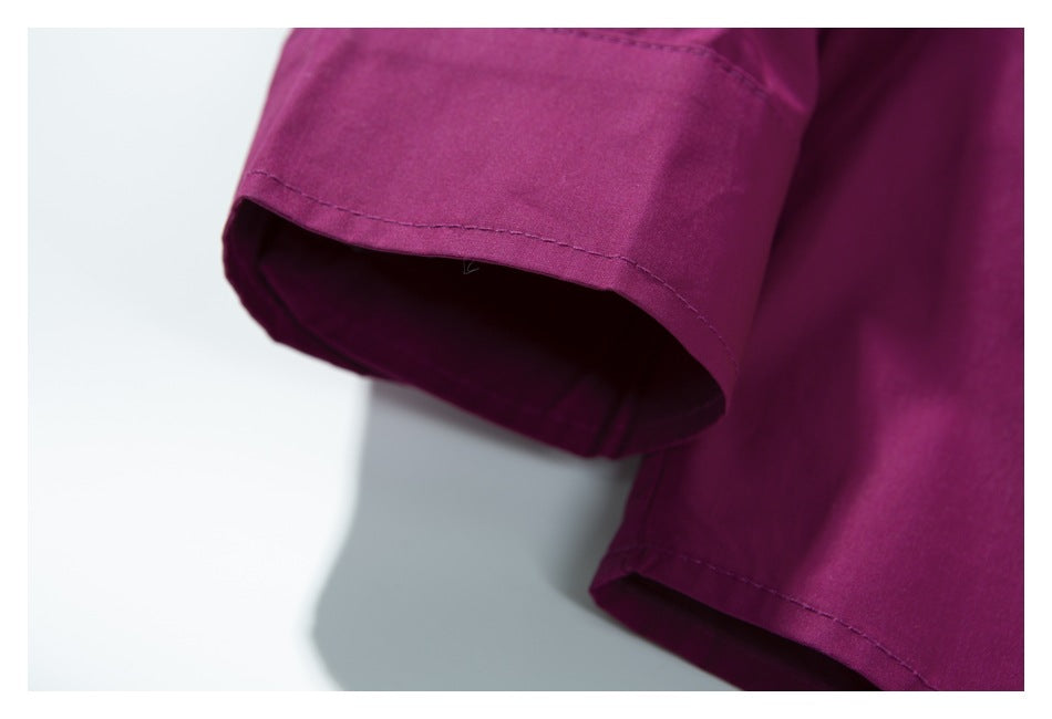 Close-up of a deep magenta garment sleeve with a neatly stitched cuff hem.
