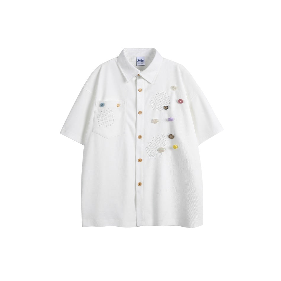 White short-sleeve button-up shirt with chest pocket, grid stitching and multicolor decorative buttons, flat front view