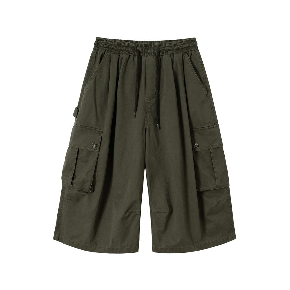 Olive green wide-leg cargo shorts with drawstring waist and large flap side pockets, front view