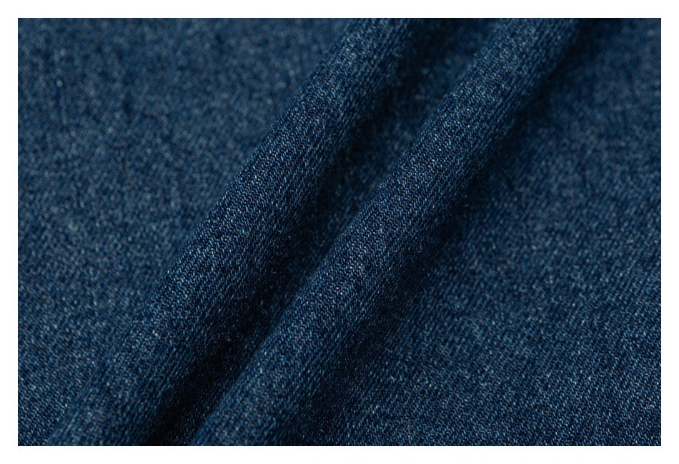 Extreme close-up of dark blue denim weave and textured fabric surface.