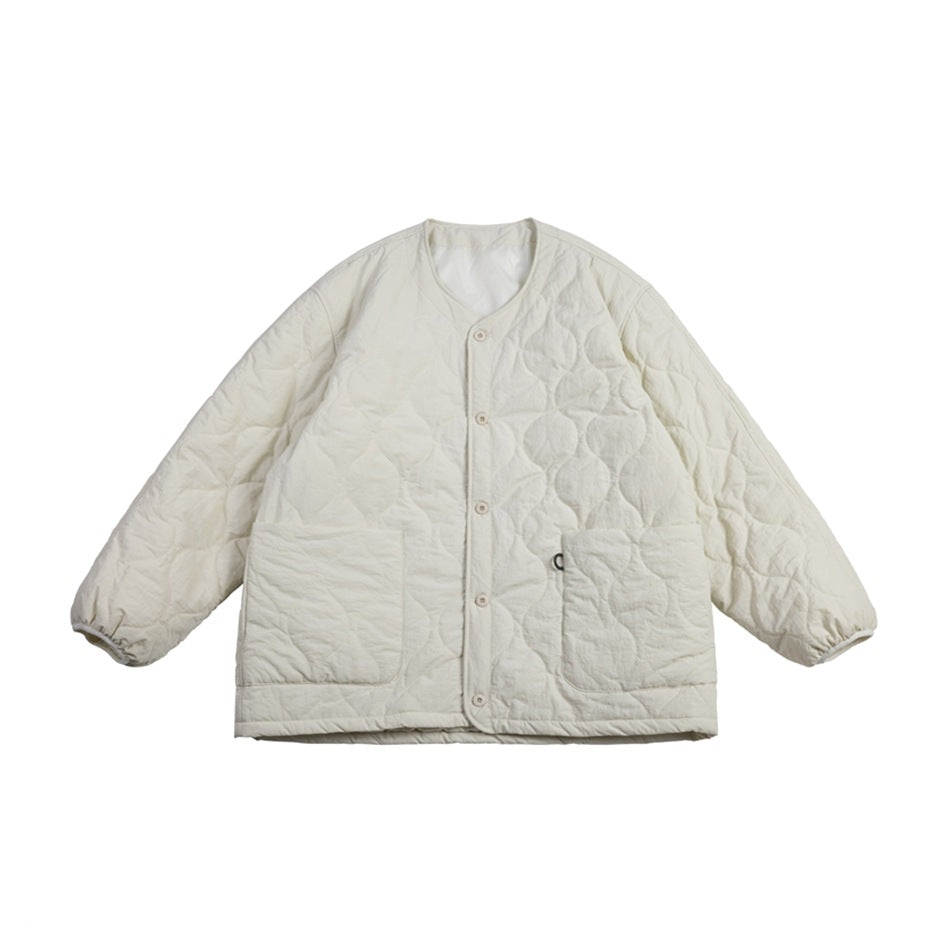 Off-white quilted collarless jacket with snap buttons, two large patch pockets and gathered cuffs, flat lay front view