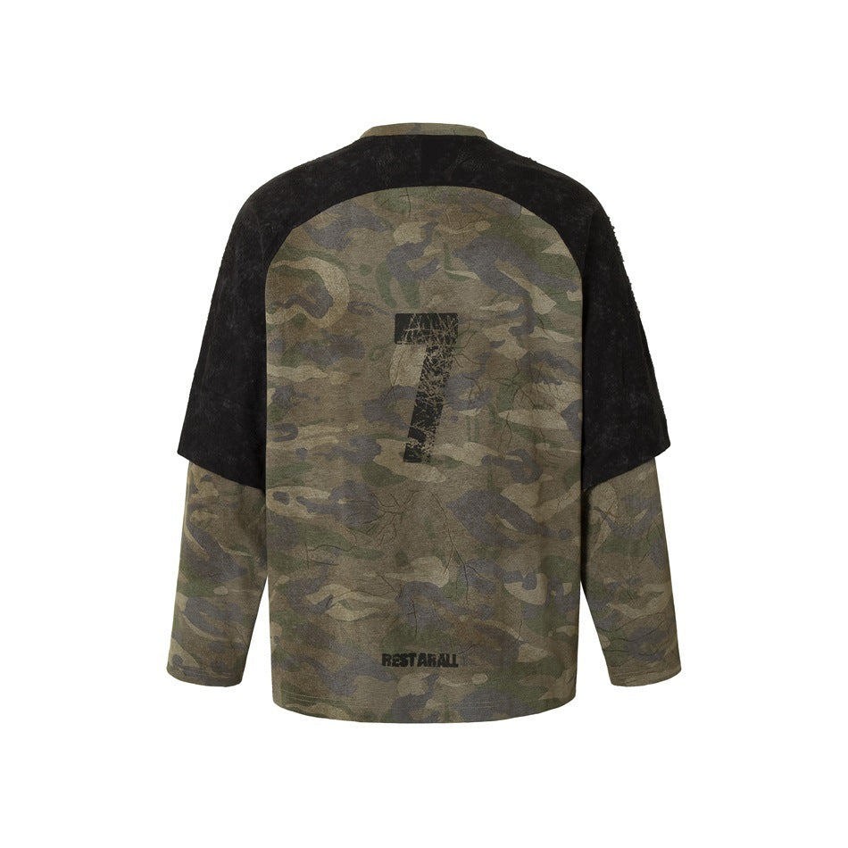 Back view of an olive camouflage long-sleeve top with black short sleeve panels and distressed graphics.