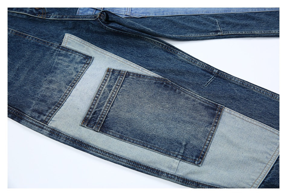 Close-up of a rear jeans pocket framed by contrasting light and dark blue denim panels.