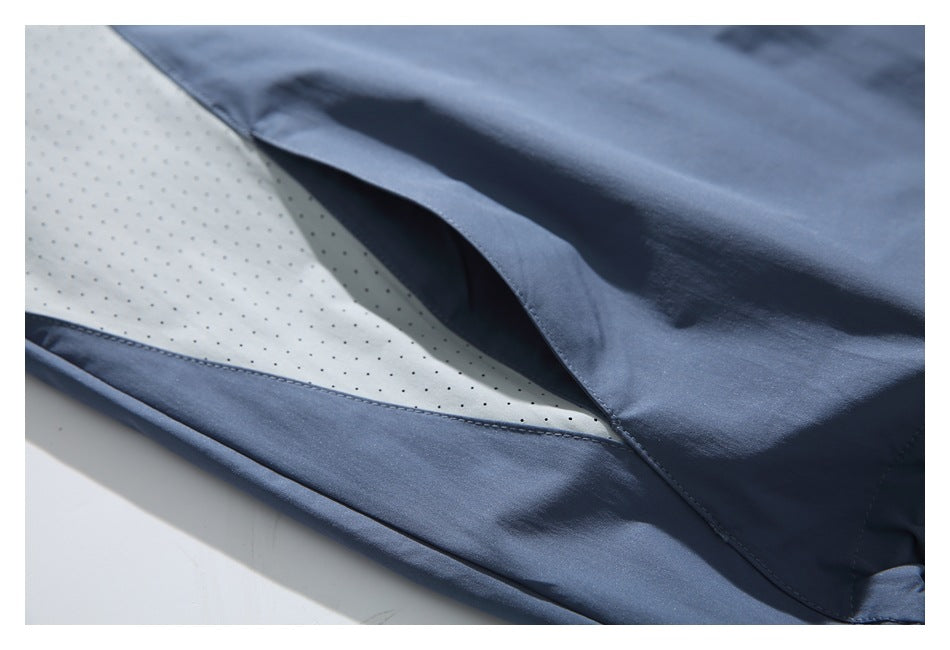 Close-up of a pale perforated insert between slate-blue jacket panels.