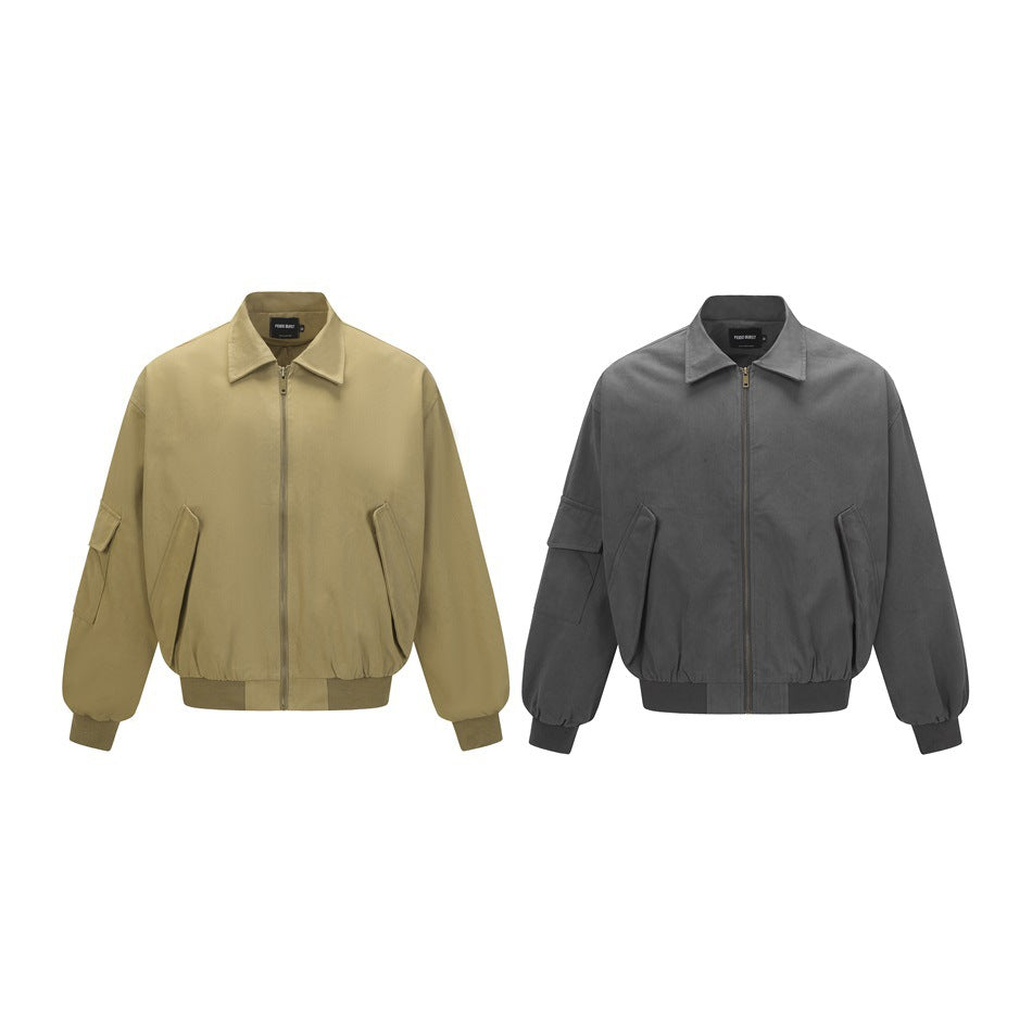 Two front views of the same oversized zip jacket, shown in olive and charcoal gray, with pointed collars and roomy sleeves.