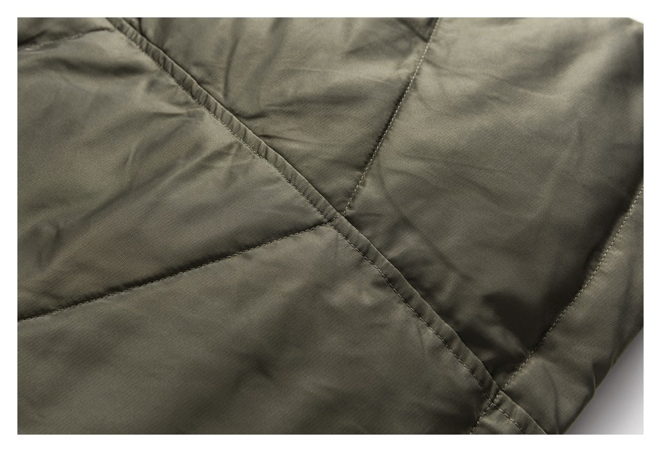 Close-up showing stitched panel seams on olive-gray jacket fabric.