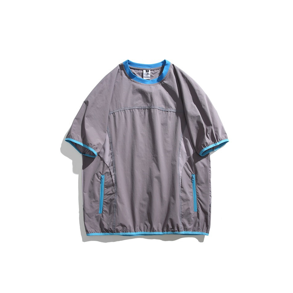 Gray-purple short-sleeve crew neck top with light blue trim and zippered side pockets, flat lay